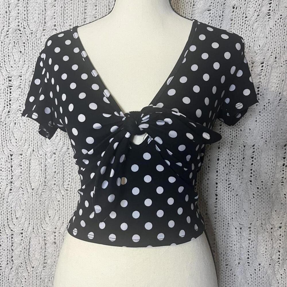Black and white polka dot cropped top with tie front detail.